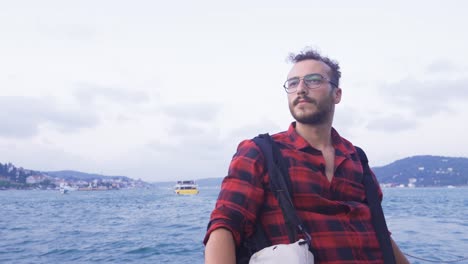 Thoughtful-man-traveling-on-ferry.