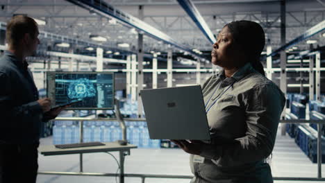 data center admin monitors deep learning process with laptop