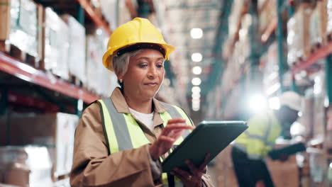 warehouse worker using tablet for inventory inspection