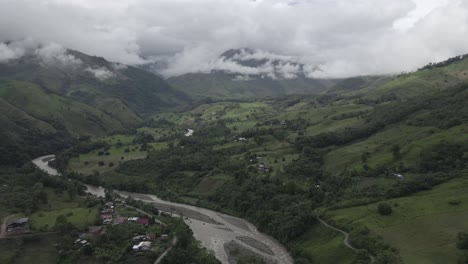 low aerial flight up green cloudy huancabamba river valley in peru