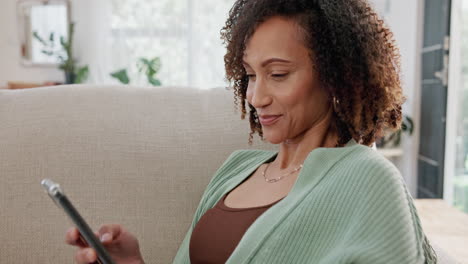 Happy Woman Sitting on a Couch and Using Her Phone