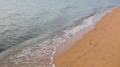 ocean waves along the sandy shores of bangsaray in pattaya, thailand