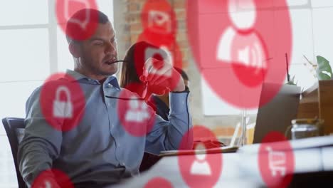 animation of network of digital icons over businessman using laptop computer