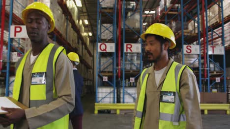 Two-managers-and-two-workers-meeting-in-a-warehouse-4k