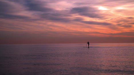 sunset at sea. man on surfboard at sunset. sea sunset. sunset landscape