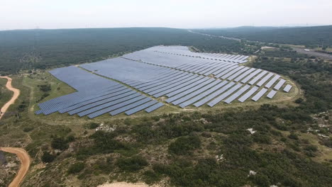 Large-aerial-view-of-a-solar-park-in-France-cloudy-day