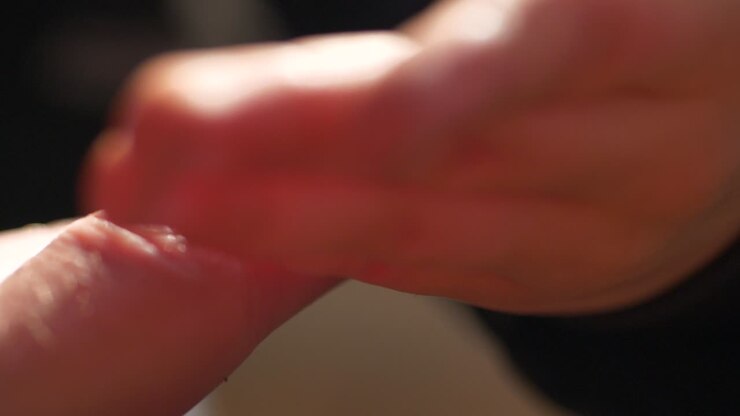 Ladybug crawling on a finger, shallow depth of field