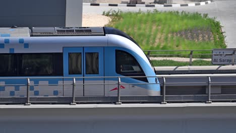 A close-up of a Dubai Metro train as it heads to its next stop along Sheikh Zayed Road in Dubai, UAE