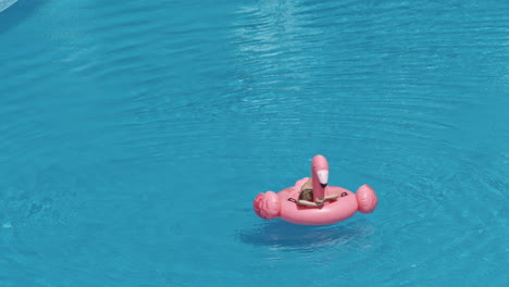 woman swimming on a blue water pool