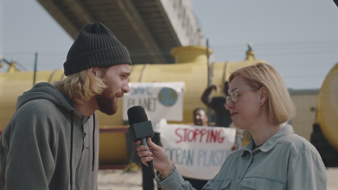 Environmental Activist Giving Interview to Journalist on Protest