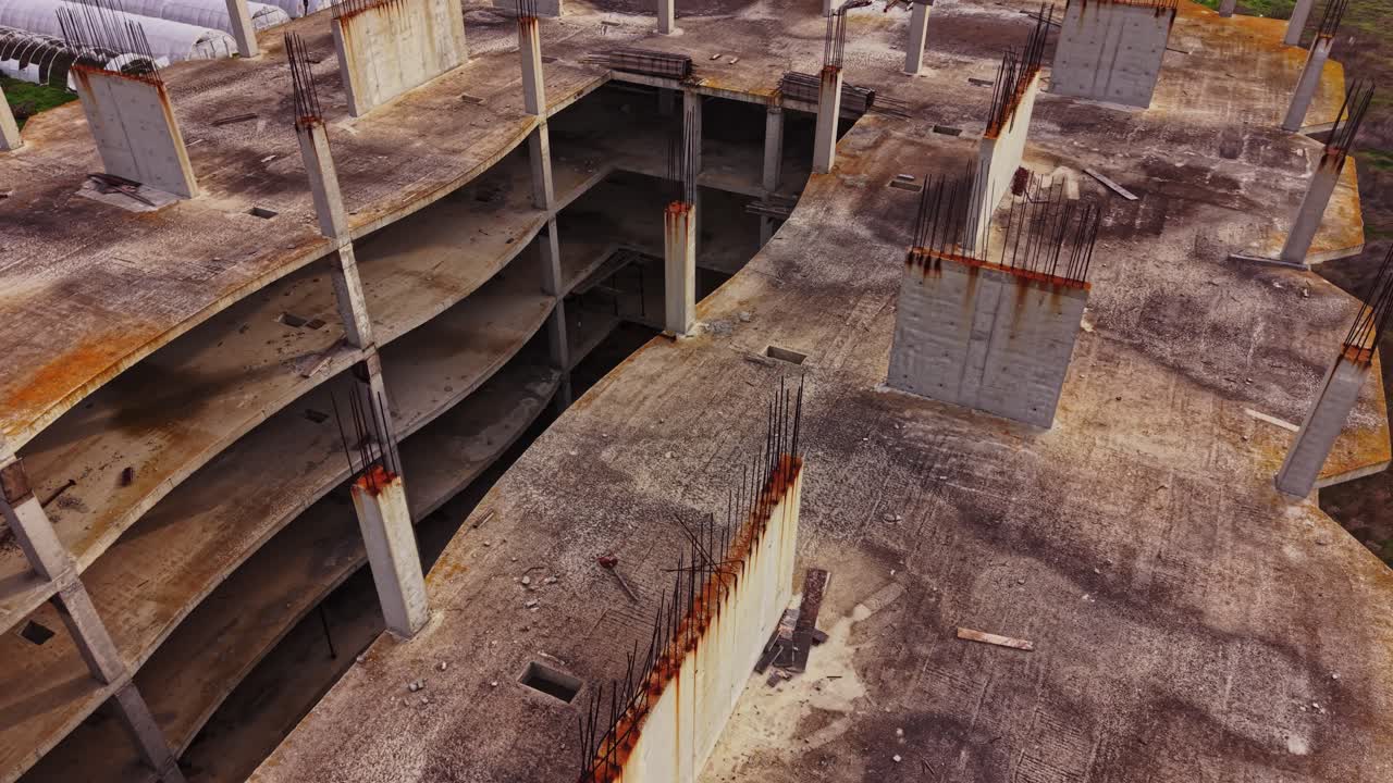 Bird's eye view of an unfinished construction site with rusty beams