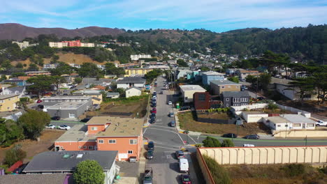 aerial view low over streets of pacifica city, sunny day in california, usa