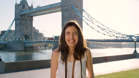 woman taking photo of tower bridge in london