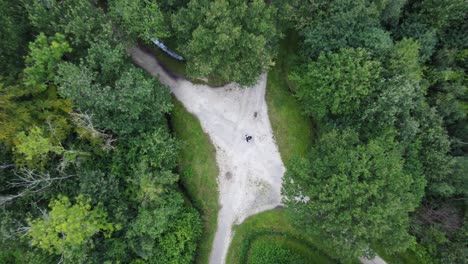 Zenital-view,-aerial-drone-shoot-of-a-crossroad-path-in-the-middle-of-a-forest