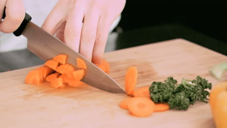 Woman-cutting-a-carrot-into-cubes-in-slow-motion