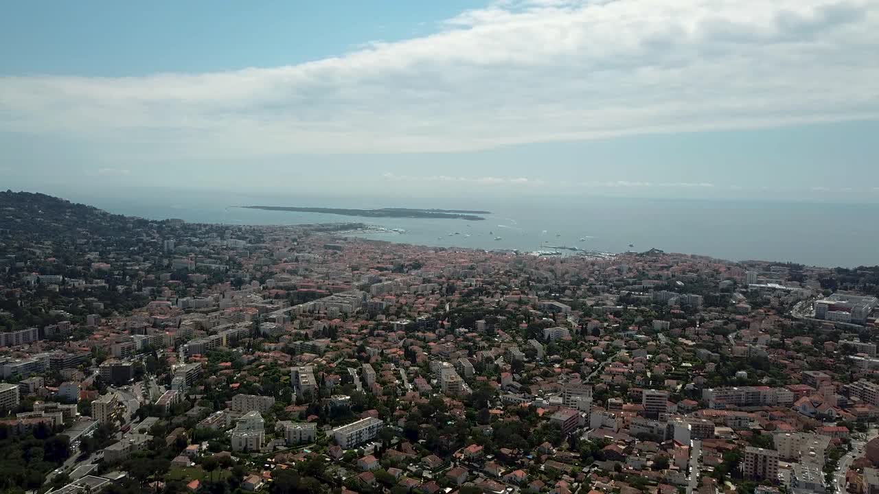 Aerial ascending shot of the city of Cannes during the famous cinema festival on a sunny day