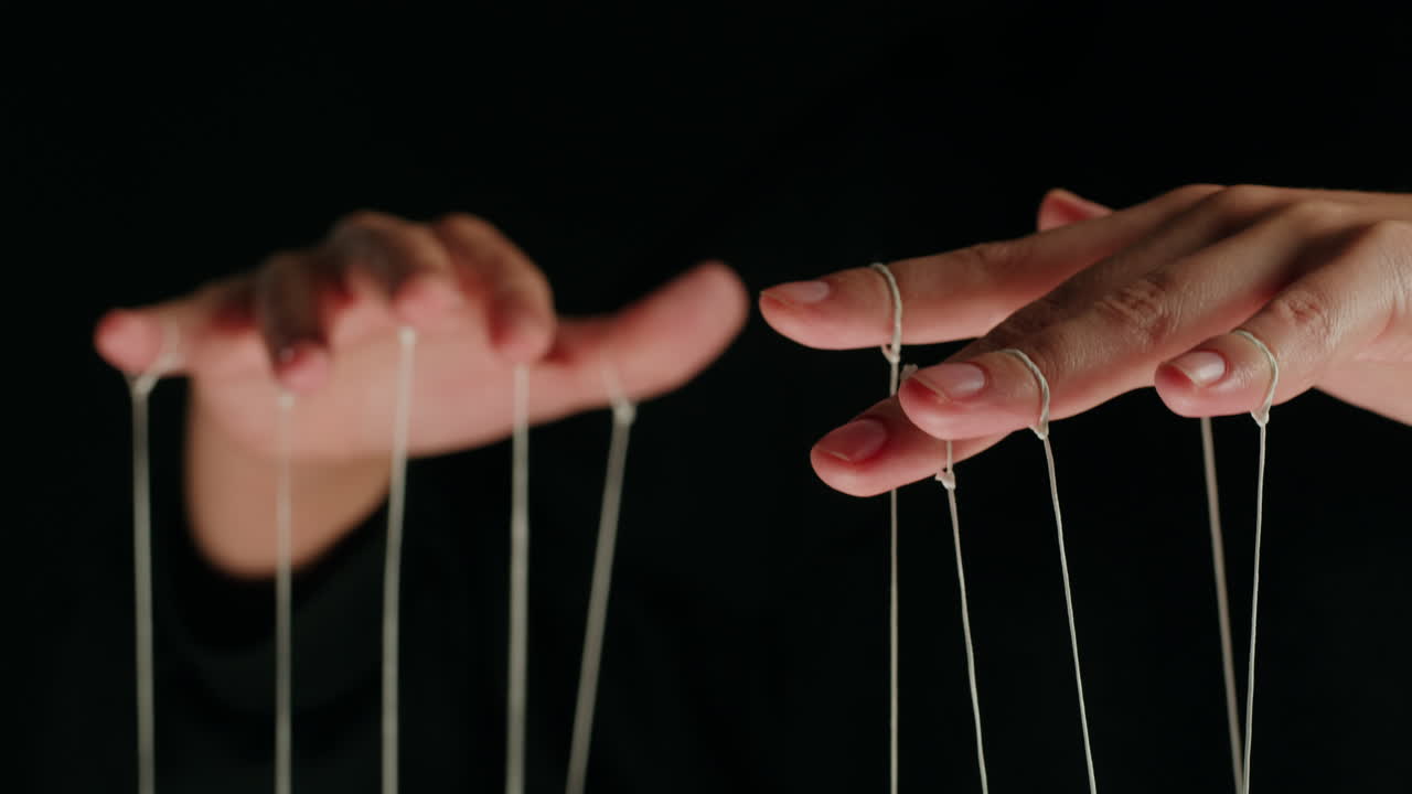 Hands Controlling Strings Like a Puppet Master