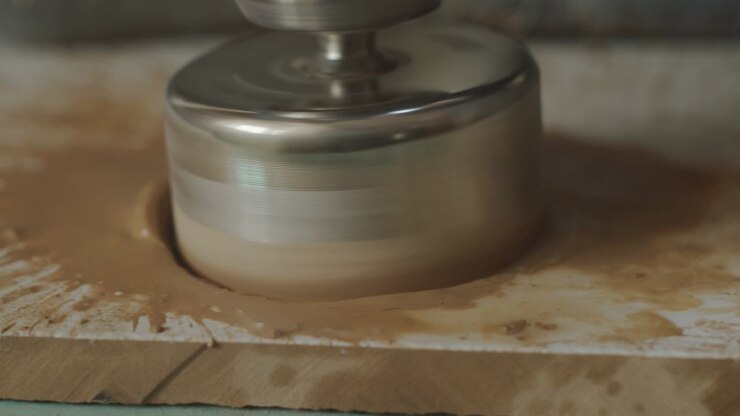 Drilling a ceramic tile with a crown, close-up. Tile processing diamond core drilling, apartment renovation