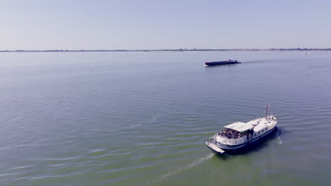 a peaceful aerial view of a luxemotor dutch boat gliding across the calm waters of flevoland in the netherlands