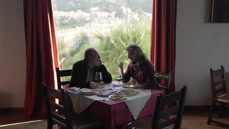 elderly couple having dinner in restaurant