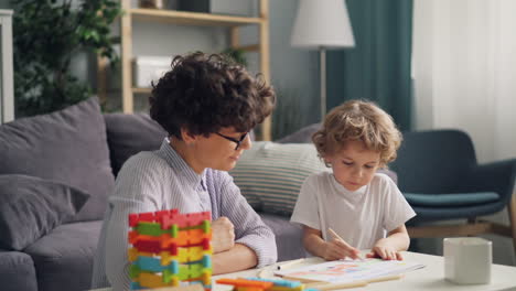 mother and son engaging in art therapy session