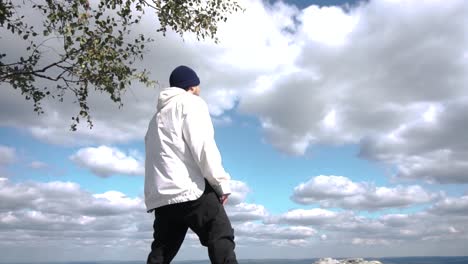 man looking at the view from a mountaintop