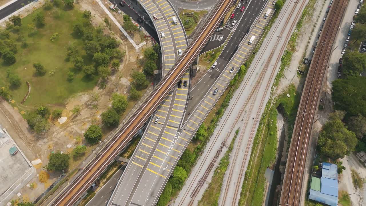 Aerial: Kuala Lumpur traffic during the day with cars and multiple roads in Malaysia, orbit drone shot
