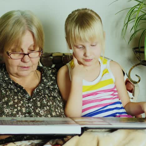 granddaughter and grandmother leafing through album