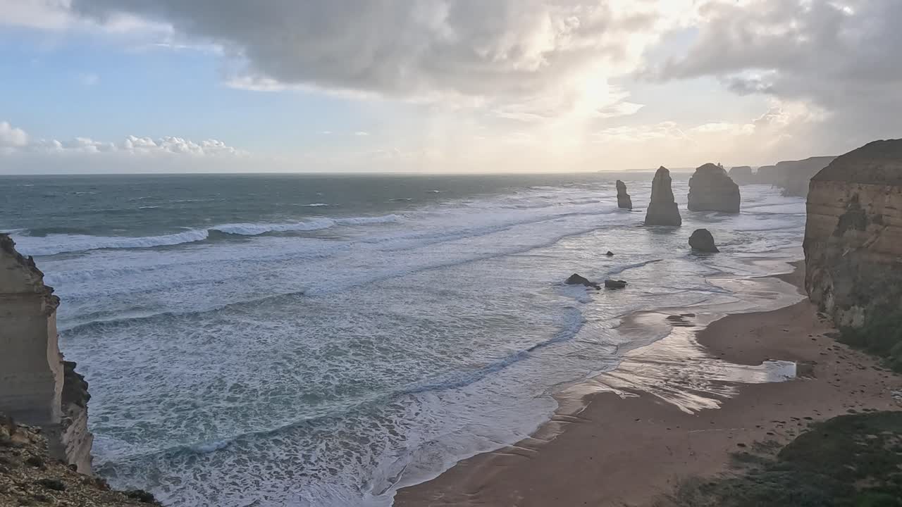 Waves crash against iconic limestone formations