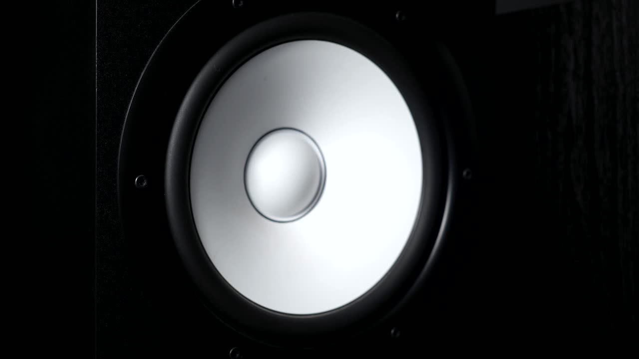 close up de mover sub-woofer em estúdio de gravação. alto-falante branco pulsando e vibrando de ouvir música alta em baixa frequência. trabalho de membrana de alto-falantes de alta fidelidade moderna. movimento lento