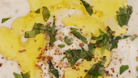 close-up of a yogurt dip with herbs and spices