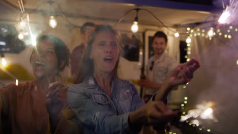 video of happy friends enjoying while holding sparklers