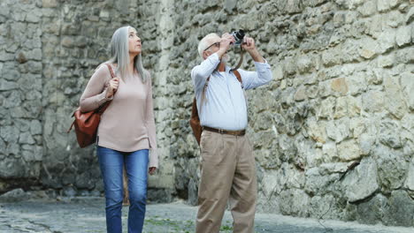 senior couple walking in the street as tourists