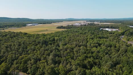 a shot of a green forest it has land in the background