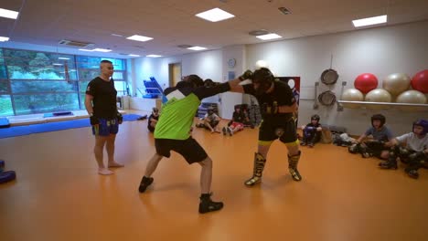 slow motion  video of a young boxer.. activity children training for boxing game. boxer trainer with children. young men playing boxing