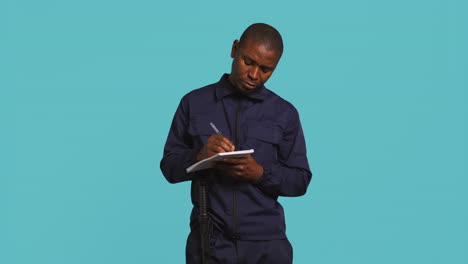 portrait of security guard using notepad to take notes of suspicious activity