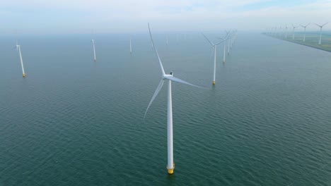 huge windmill turbines, offshore windmill farm in the ocean westermeerwind park , windmills isolated at sea on a beautiful bright day netherlands flevoland noordoostpolder