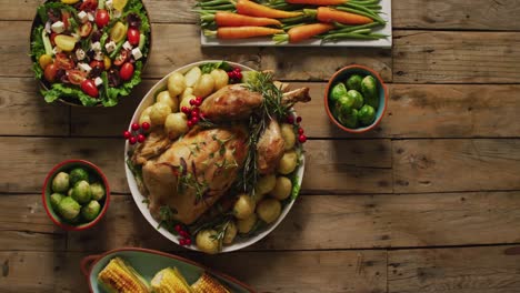 video of tray with roasted turkey, potatoes and vegetable on wooden surface