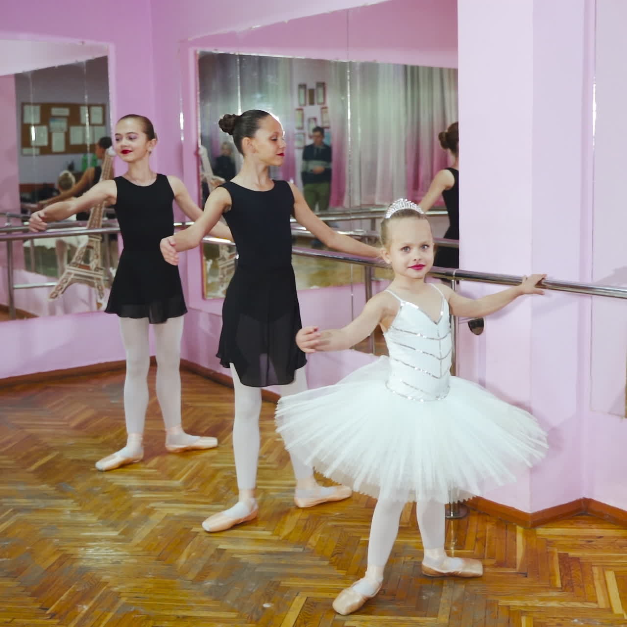 Three Young and Graceful Ballerinas Practicing Their Dance. They Wear Black Tutus and White Tights. Shot in a Modern Studio. In Slow Motion.