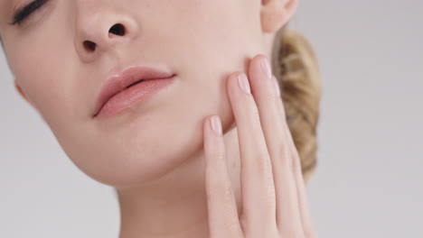 beauty portrait of woman touching beautiful face slow motion skincare concept on a grey background slow motion red epic dragon