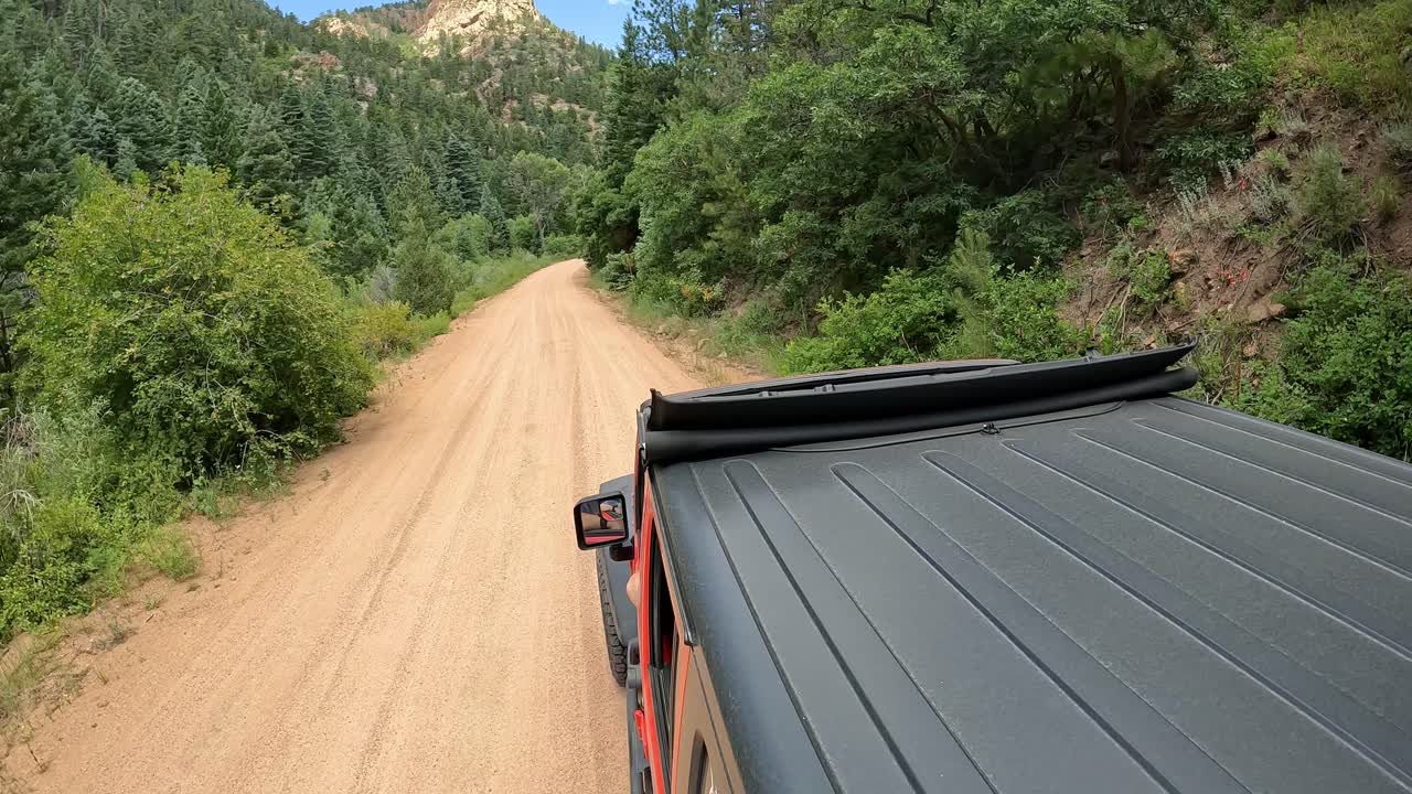 POV - View of vehicle rooftop driving on Phantom Canyon Road
