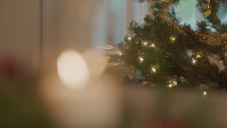 christmas decorations include garland and a white flickering candle