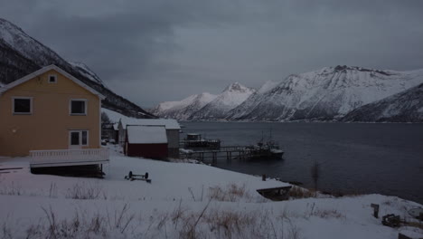 aerial dolly towards apartments and docks at fjordgard, senja, norway