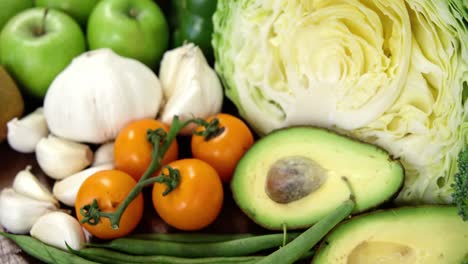 Variety-of-fresh-colored-vegetables-and-fruits-on-wooden-table