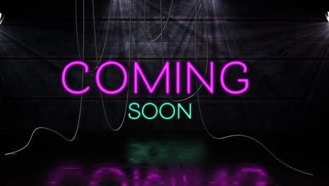 animation of coming soon text in pink and blue neon, with hanging cables on black background