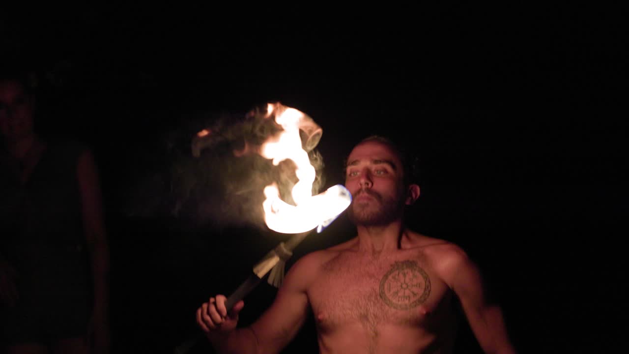 Man Fire breathing show night badass beach dangerous