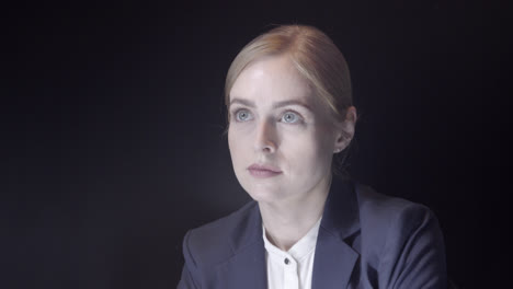 portrait of a confident female business leader shot in a studio with black background