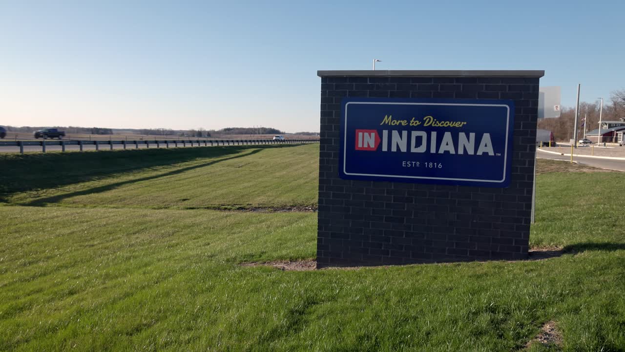 Indiana, More to Discover sign at a rest area along I69 in Indiana vehicles driving by and video panning right to left