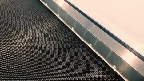 first person view point of view of riding travelator at a train station whilst looking at the travelator