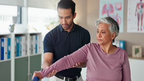 physical therapist assisting patient with arm exercise